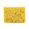 Yellow floral soap bar on a white background